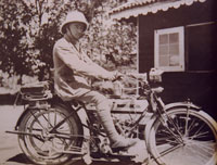 Colonial official on a motorcycle