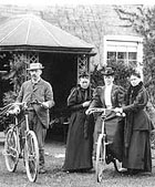 An old photograph of a family posing with bicycles