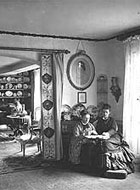 A photograph of two women in a drawing room