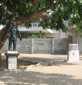 Photo of a sculpture of a figure on a plinth on the Slaves' route in Ouidah